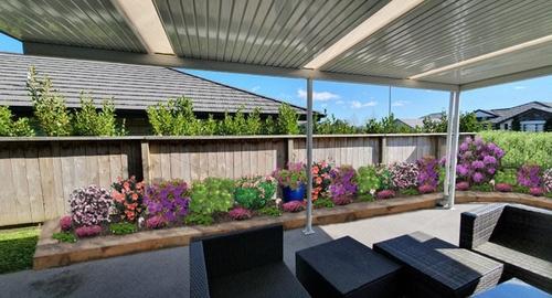 Widening the garden, removing the sandpit, planting with chosen shrubs and ground covers.