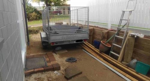 Requiring a garden shed and some planting to soften the area and retained wall.