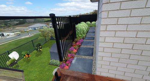 Soften area with annuals, small hedge and stones around pavers