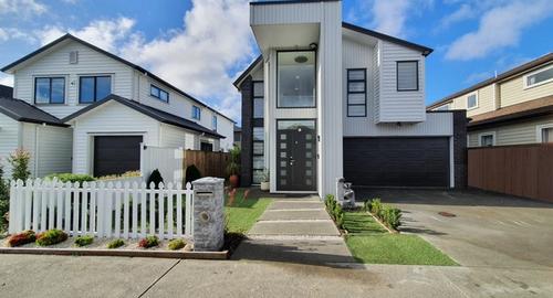 Modern home with a dated entry. To many variety of shrubs and a picket fence that is not in keeping with a modern home. No privacy or security from the public footpath to the front door.